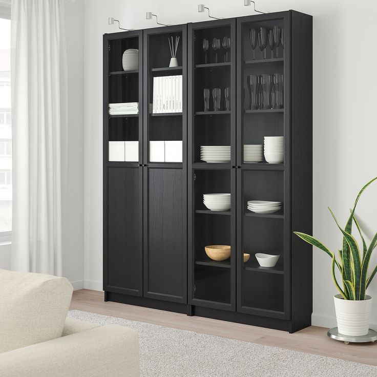 a black bookcase with glass doors in a living room