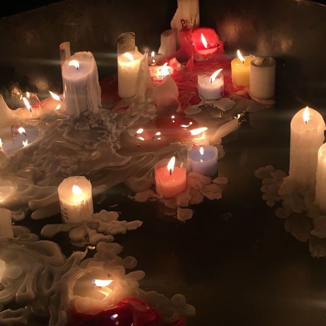 many lit candles are arranged in a circle