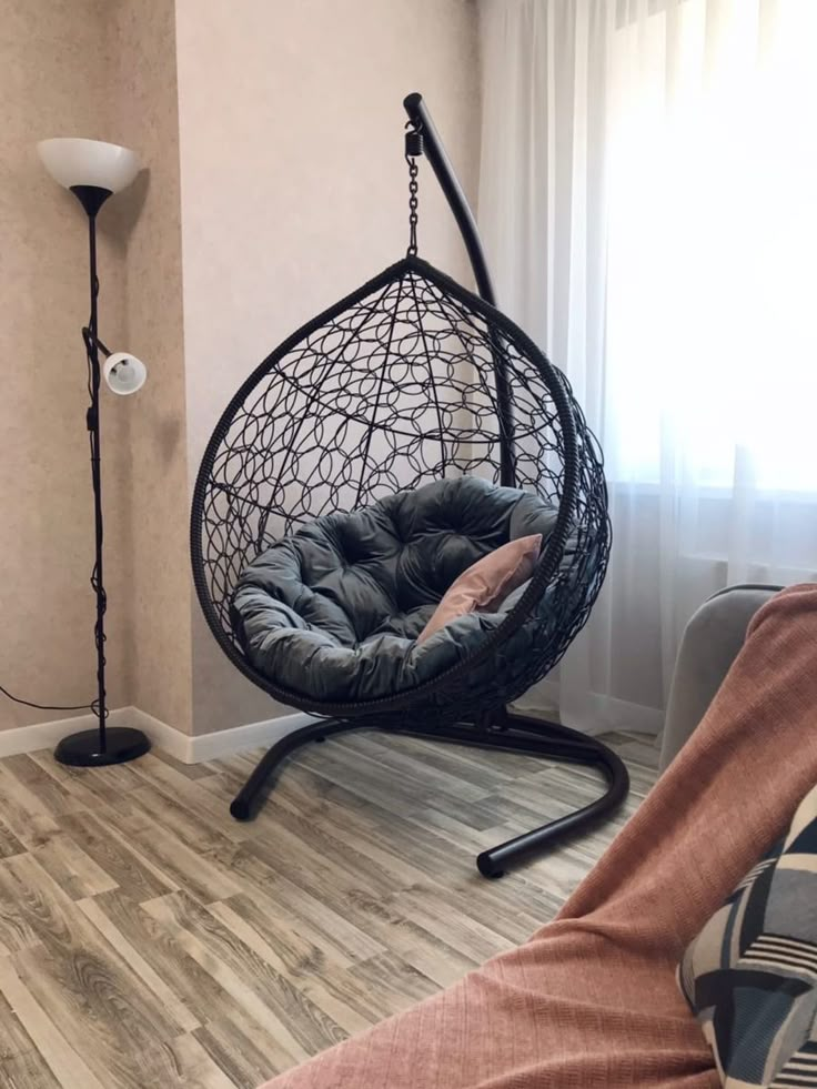 a hanging chair in the corner of a room