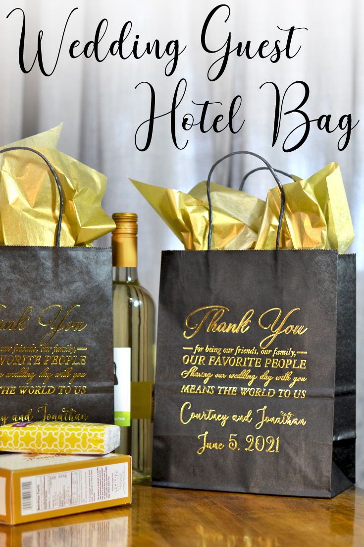 the wedding guest hotel bag and wine bottle are sitting next to each other on a table