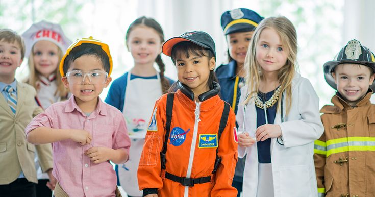 a group of children dressed in costumes posing for a photo with one boy giving the thumbs up