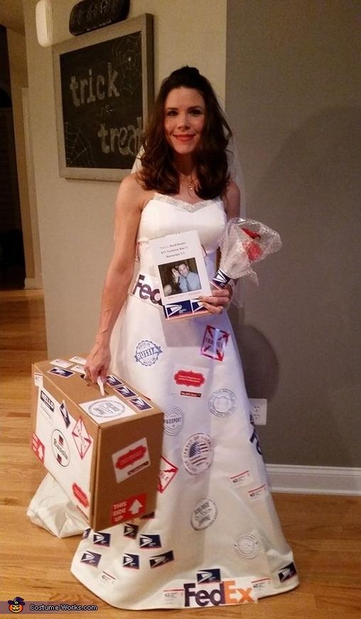 a woman in a white dress holding two boxes