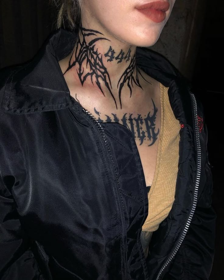 a woman with tattoos on her neck and chest