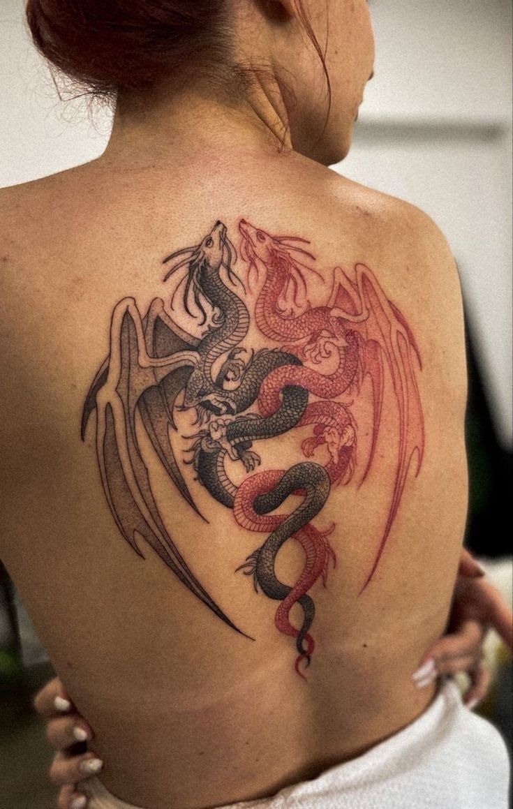 a woman with a dragon tattoo on her back