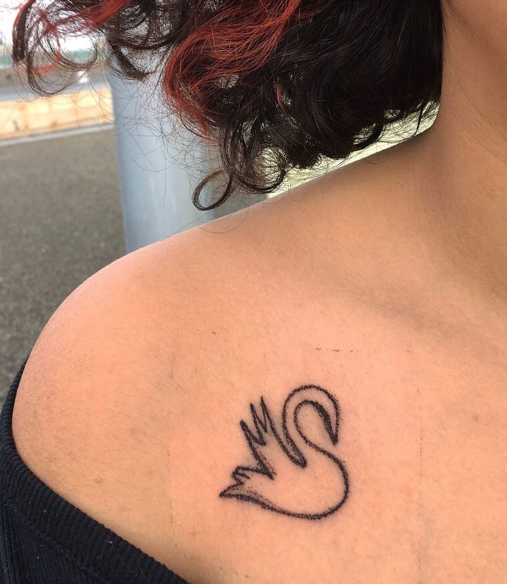 a woman with a tattoo on her shoulder