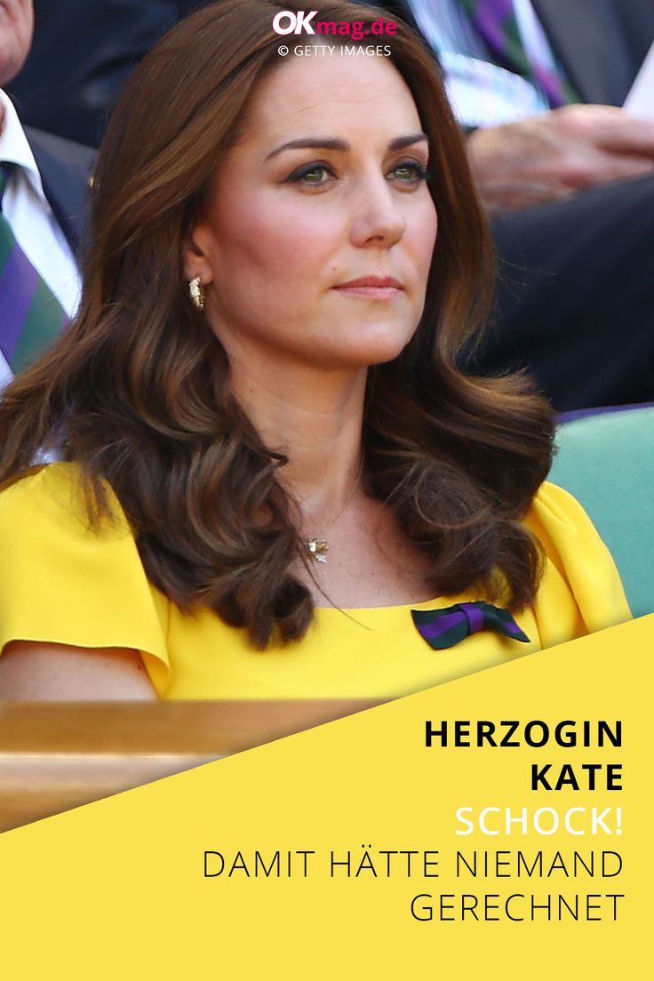 a woman in a yellow dress sitting next to a man wearing a suit and tie