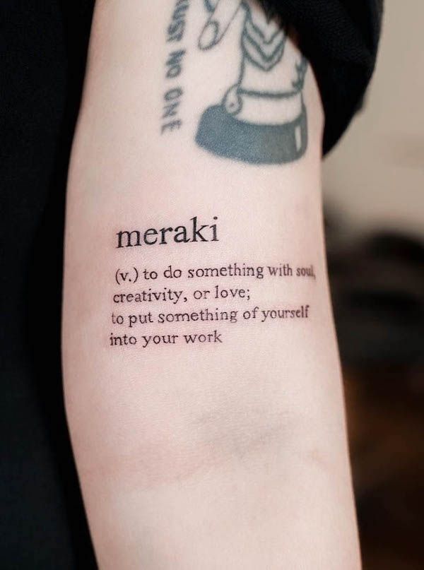 a person with a tattoo on their arm that says merakv to do something with you creativity, or love, to put something of yourself into your work