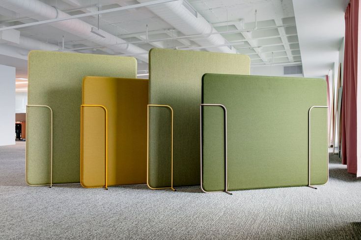 four different colored chairs in an office setting