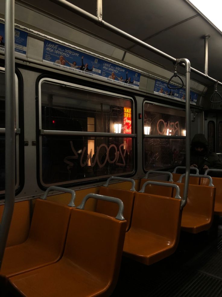 an empty subway car with orange seats