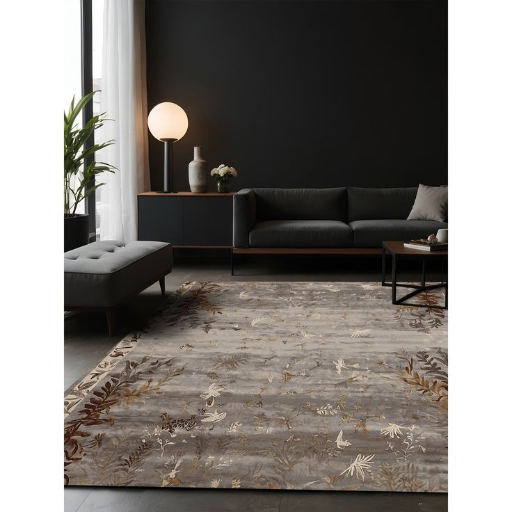 a living room with a couch, coffee table and rug on the floor in front of a window