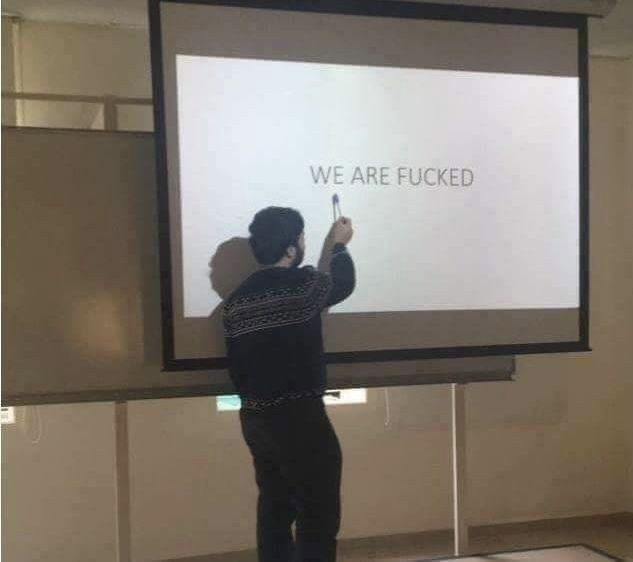 a man standing in front of a projection screen