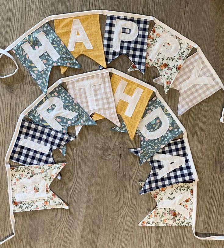 happy birthday bunting banner on wooden floor with fabric letters and gingham checkers