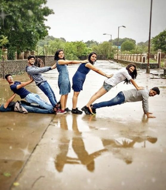 a group of people standing in the middle of a puddle