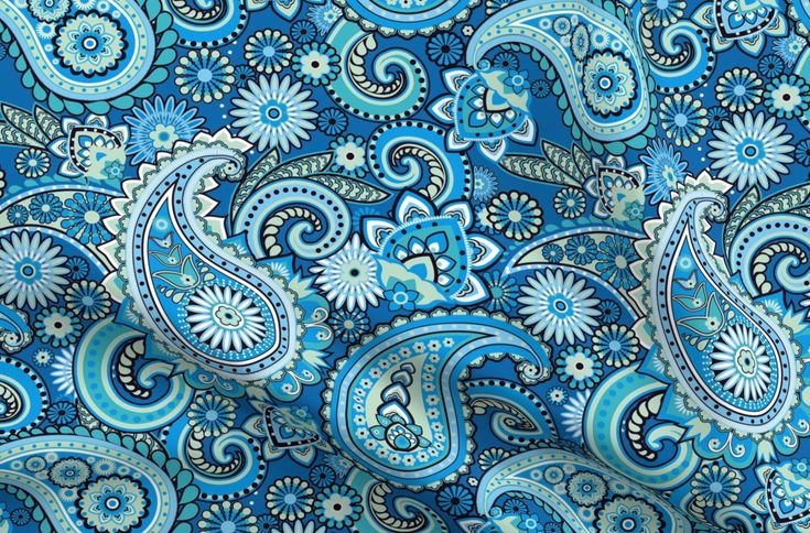 a blue paisley print fabric with many different colors and patterns on it, including flowers