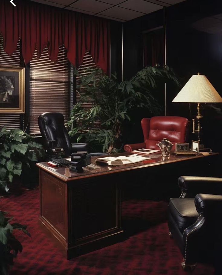 an office with red carpeting and black leather chairs in front of a large desk