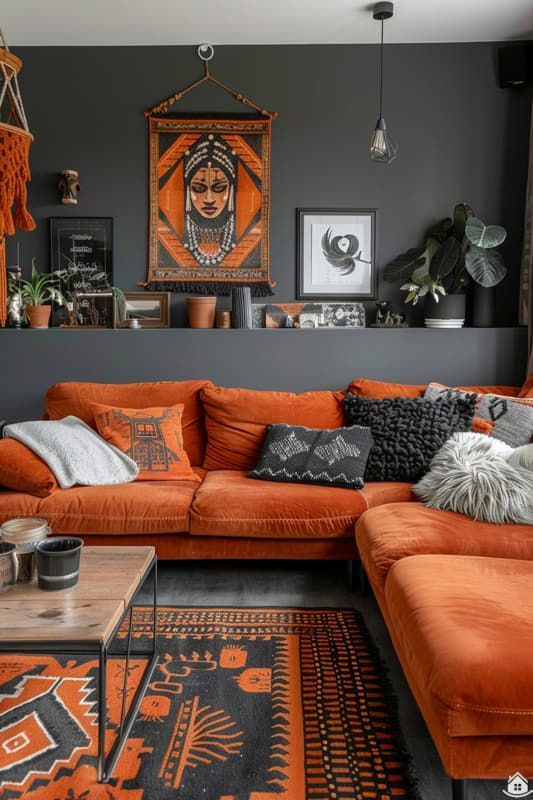 a living room with orange couches and rugs on the floor, in front of a black wall