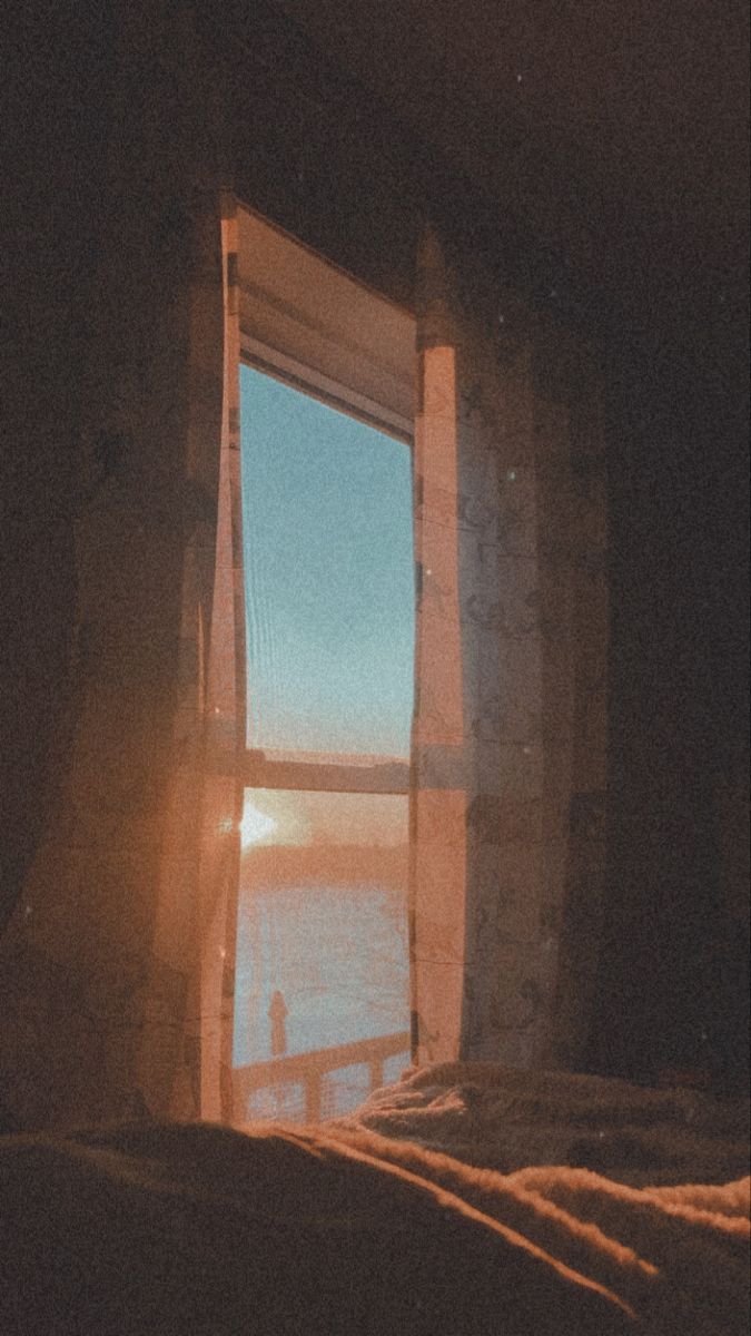 the sun shines brightly through an open window on a bed in front of a body of water