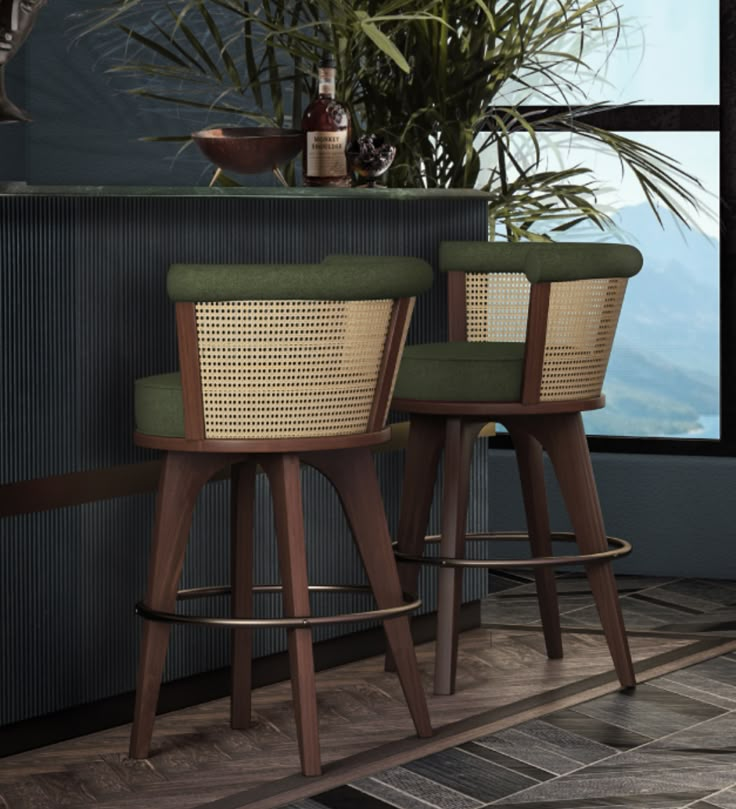 two wooden stools with green upholstered seats in front of a window and potted plant