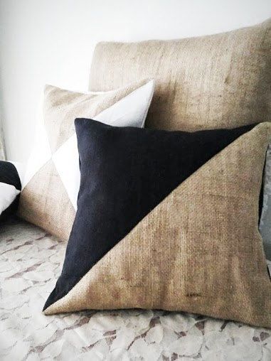 two black and white pillows sitting on top of a bed