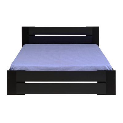 a black bed frame with blue sheets and pillows on it, against a white background