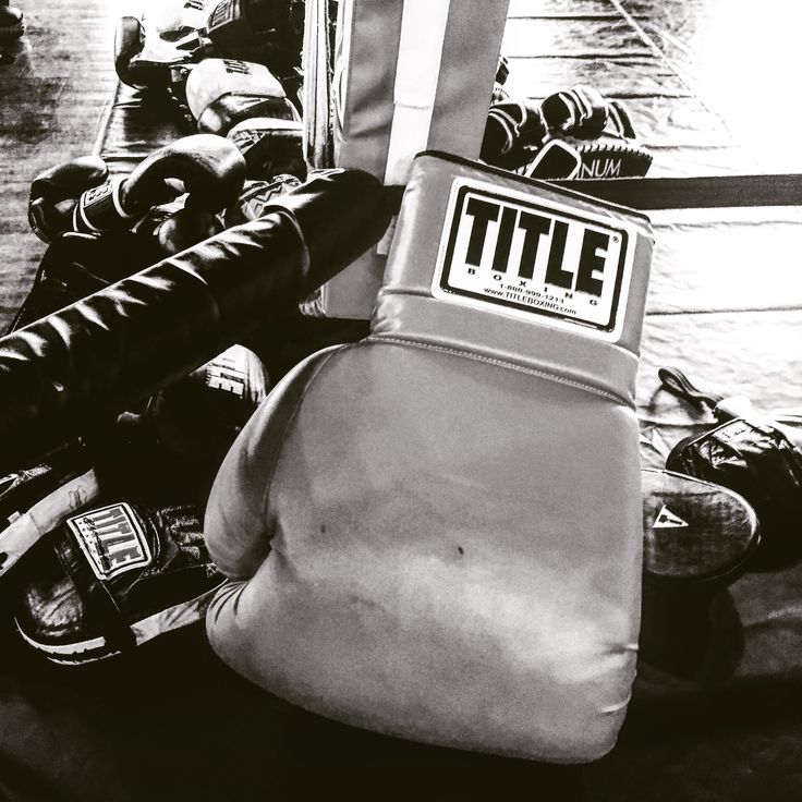 black and white photograph of boxing gloves on the ground