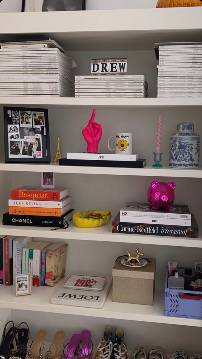 a white book shelf filled with lots of books and other items on top of it