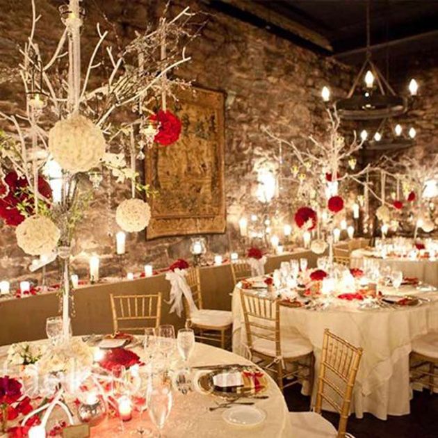 the tables are set with white and red centerpieces, candles, and flowers