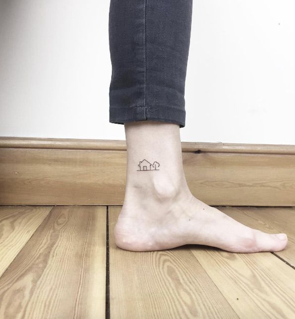 a woman's foot with a small tattoo on her left ankle and the word home written below it