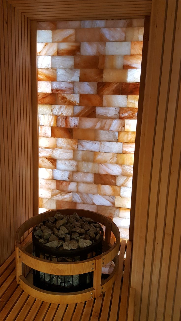 the inside of a sauna with wood and glass panels on the wall behind it