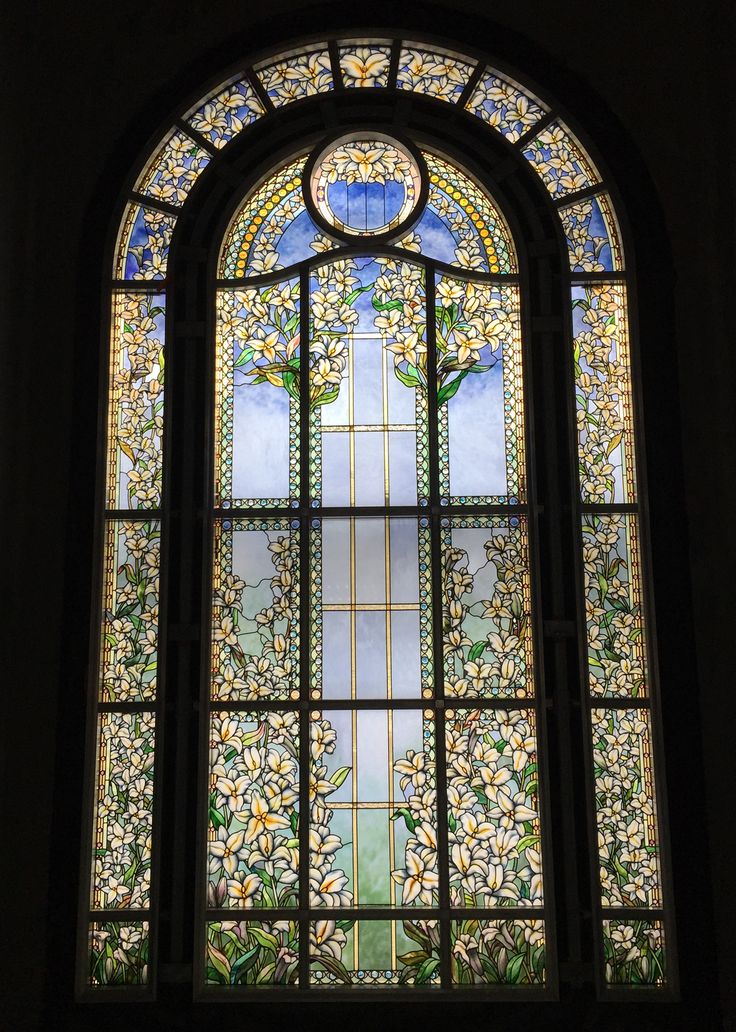 an ornate stained glass window with flowers on it