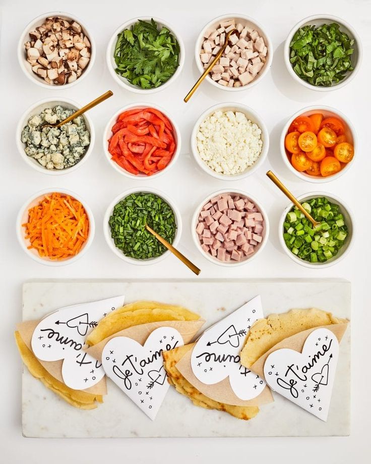 a table topped with bowls filled with different types of vegetables and meats next to each other