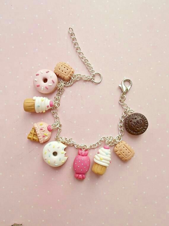 a bracelet with different types of doughnuts and cookies hanging from it's sides