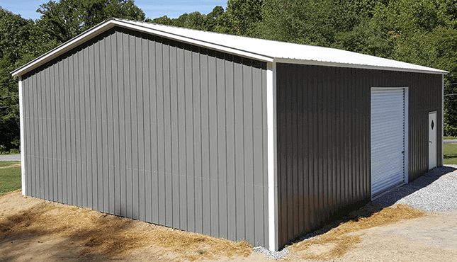 an empty garage in the middle of a field