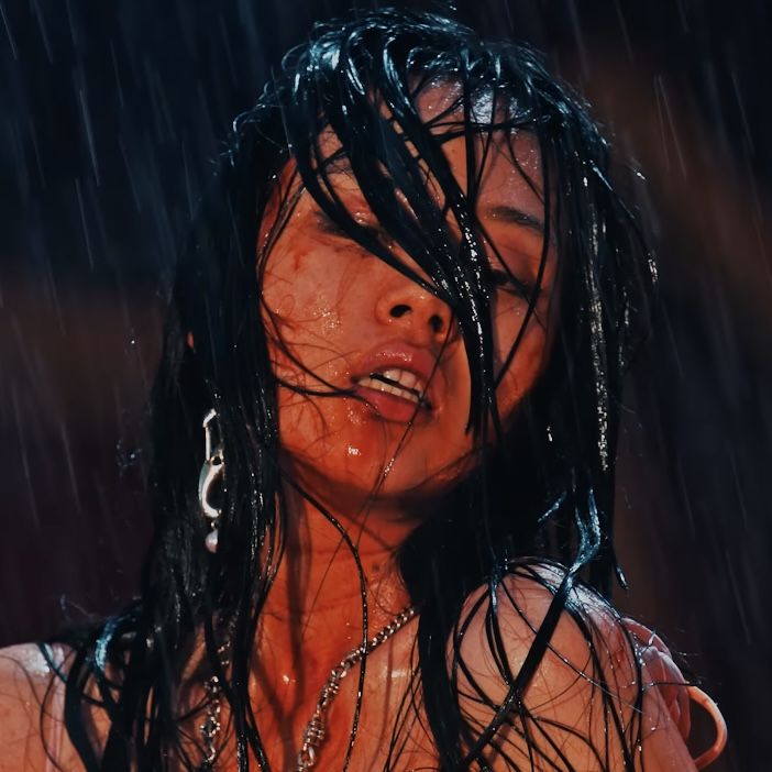 a woman with wet hair standing in the rain