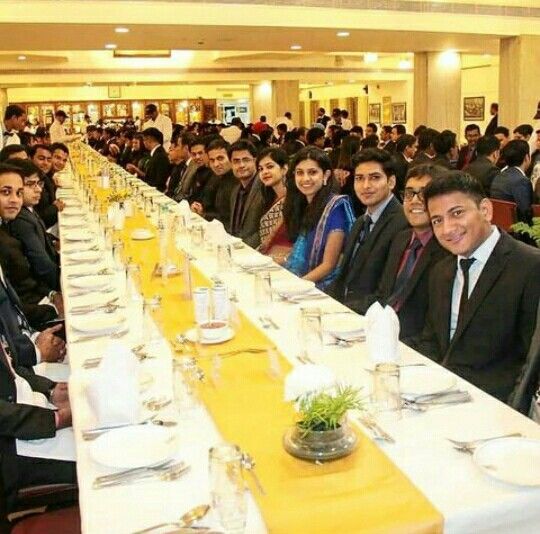 a large group of people sitting at long tables