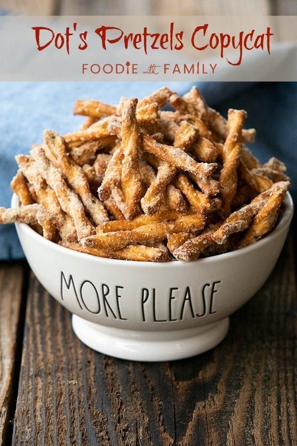 a white bowl filled with french fries on top of a wooden table