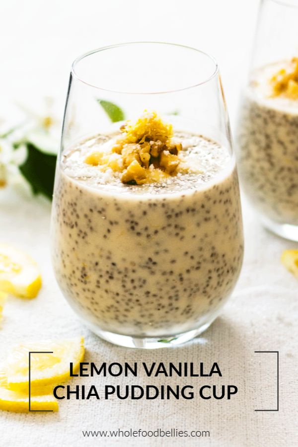 two glasses filled with food sitting on top of a white table covered in lemon slices