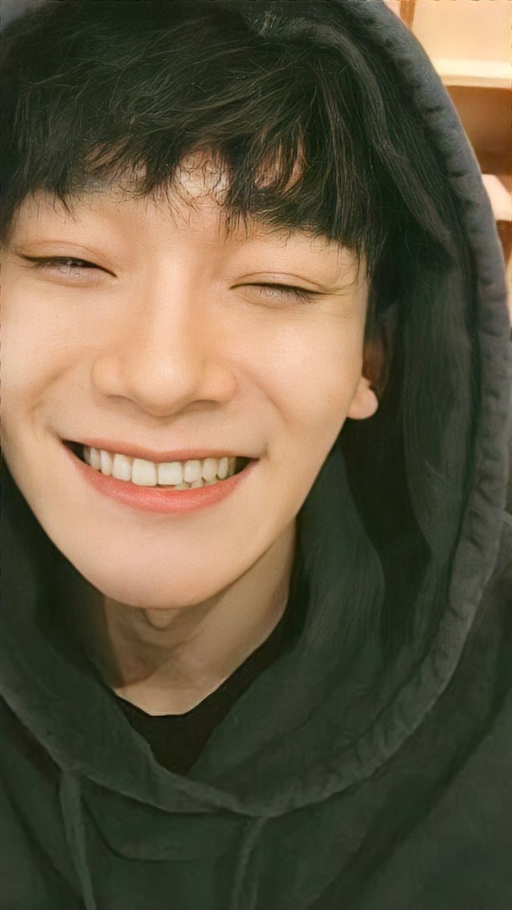 a person wearing a black hoodie and smiling