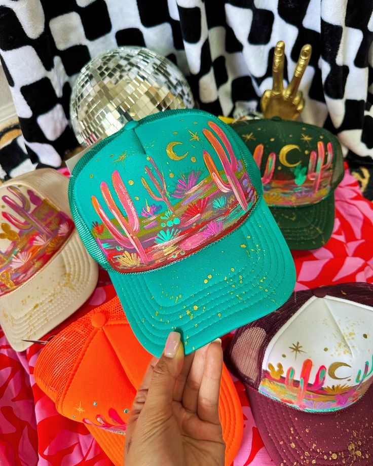 Over 30 new hand painted hats just went live! 🔥 Florals fedoras marked $65 OFF and hand painted desert trucker hats!! Woohoo! 💖 these are sooooo cool and beautiful! I was listening to @radvxz while I made these because right now that’s all I can listen too! 😭 I’m kinda obsessed with her music! #truckerhat #truckerhats #hatbar #cowgirlstyle #cowgirlfashion Painting Hats Diy, Painted Trucker Hats Diy, Hand Painted Trucker Hats, Painted Hats For Women, Painted Trucker Hats, Trucker Hat Ideas, Hand Painted Hats, Textured Hat, Burned Hats