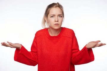 a woman in a red sweater is holding her hands out and looking at the camera