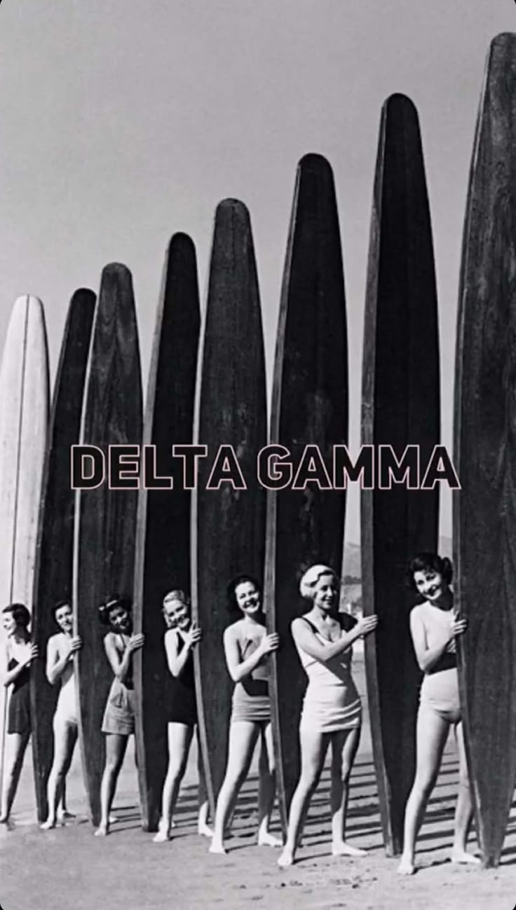 several women in bathing suits standing next to surfboards with the words delta gama on it