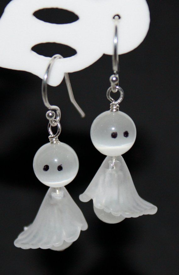 the earrings are made out of glass and have small white beads on each earring