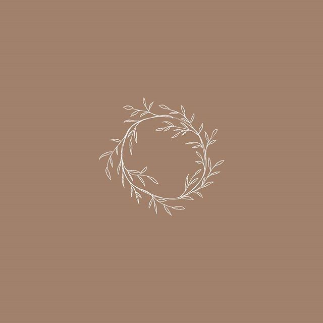 a white wreath on a brown background with the word love written in cursive writing