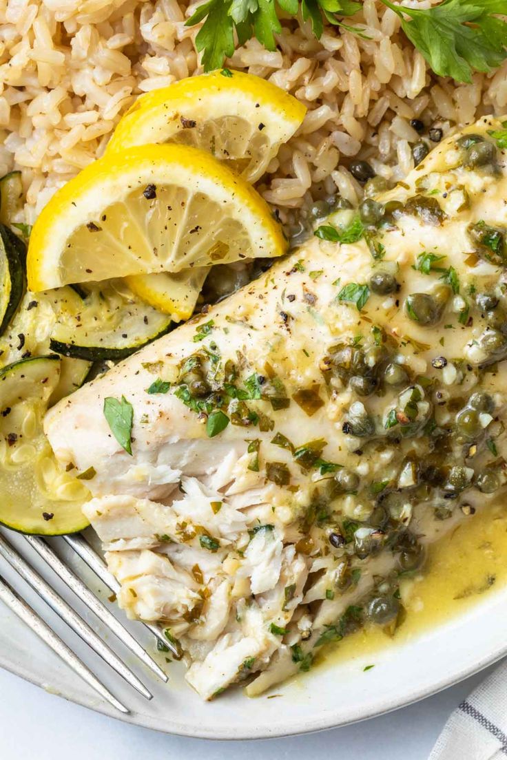 baked mahi mahi with lemon and parsley on the side, served over rice