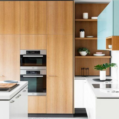 a kitchen with wooden cabinets and white counter tops