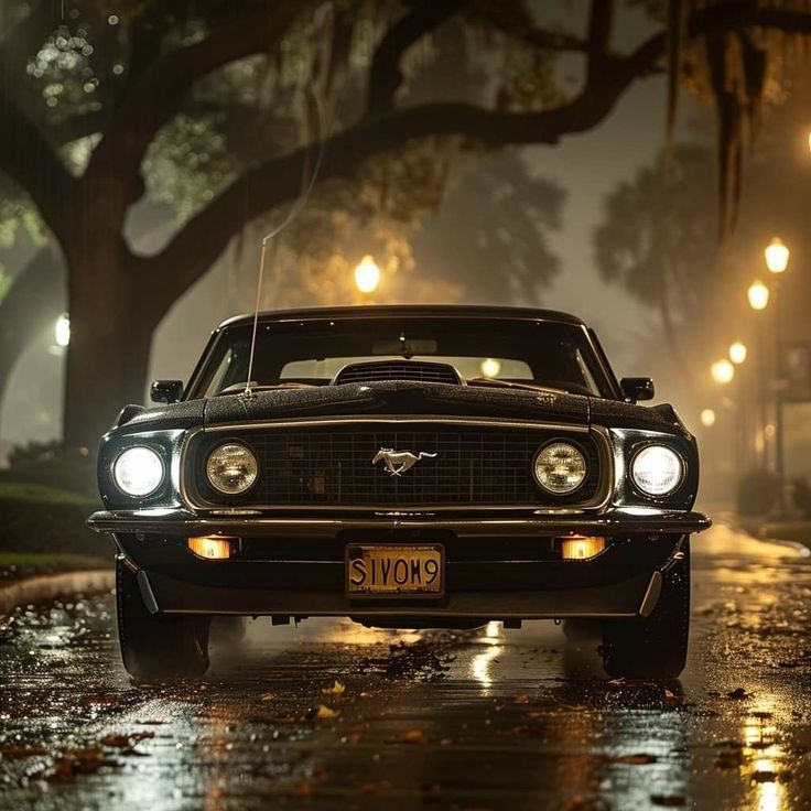 a car parked on the side of a road in the rain at night with its lights on