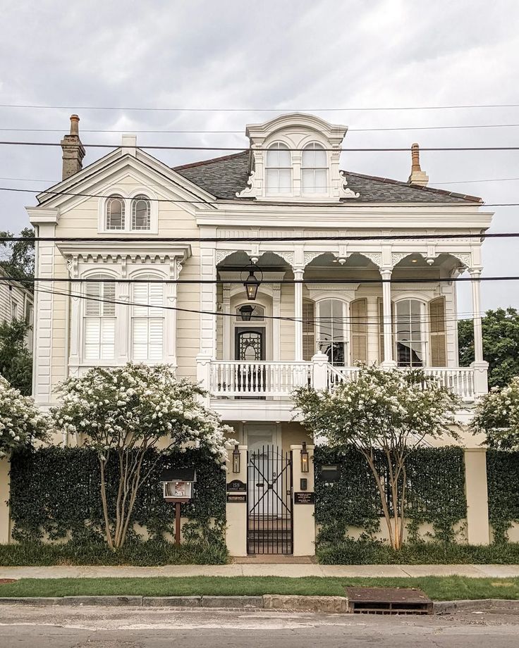 a large white house sitting on the side of a road