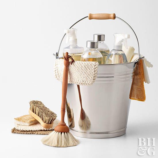 a white bucket filled with lots of different types of bathroom items next to a brush