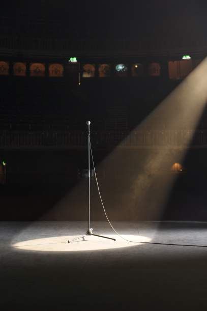 an empty stage with light coming from the spotlight