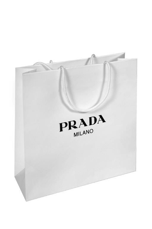 a white shopping bag with the words prada in black on it's side